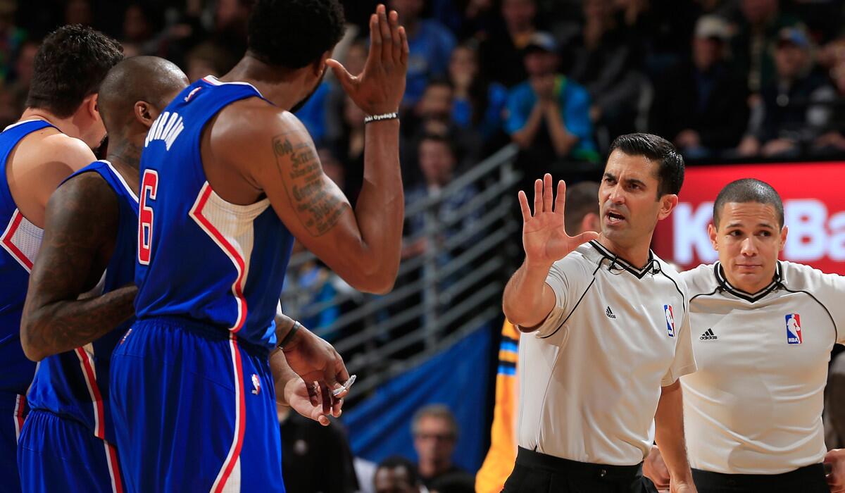 Referee Zach Zarba (28) directs Clippers players to their bench after center DeAndre Jordan (6) was called for a flagrant foul against Nuggets forward Kenneth Faried (not pictured) during their game Friday night in Denver.