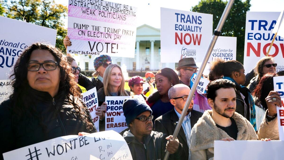 People gather outside of the White House on Oct. 22 to protest the Trump administration's proposal to define gender as unchangeable once determined at birth.
