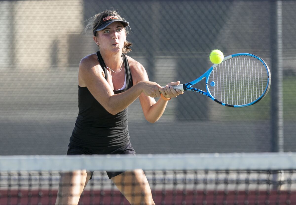Huntington Beach's Kayla Friedland returns a backhand during a Surf League match on Tuesday at Huntington Beach High.