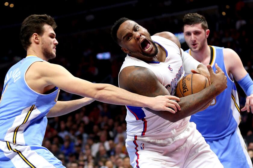 Clippers center Glen Davis grabs a loose ball during a game against the Denver Nuggets on Jan. 26.