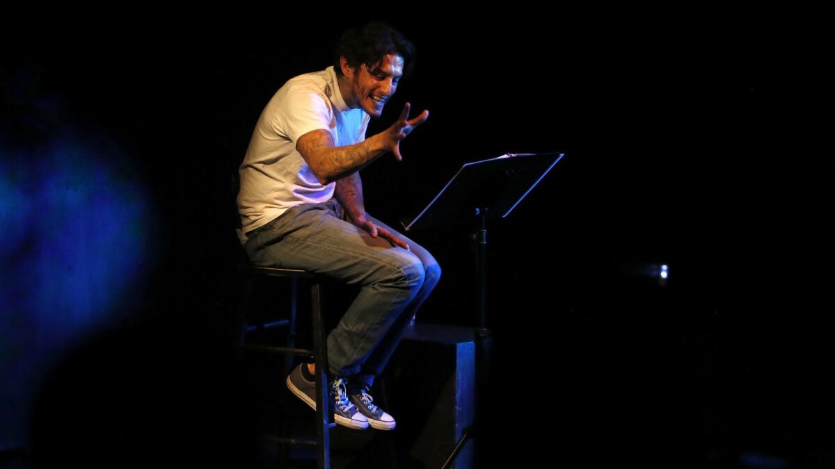 Richard Cabral performs "Time Alone" at the Pico Playhouse, in front of high school students from South Los Angeles.