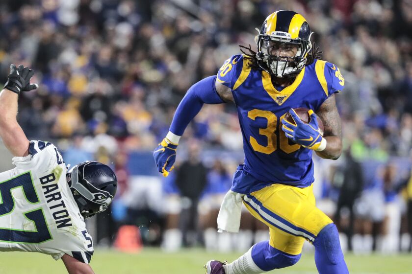 LOS ANGELES, CA, SUNDAY, DECEMBER 8, 2019 - Los Angeles Rams running back Todd Gurley (30) turns the corner by Seattle Seahawks linebacker Cody Barton (57) during a second quarter touchdown drive at LA Memorial Coliseum. (Robert Gauthier/Los Angeles Times)