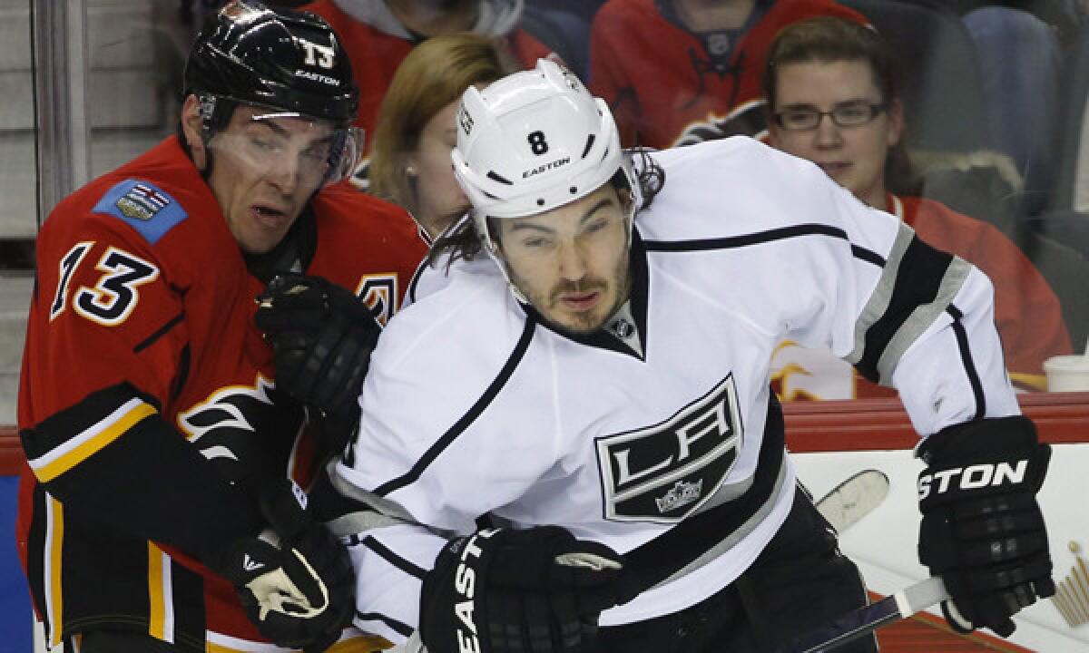 Kings defenseman Drew Doughty, right, checks Calgary Flames center Mike Cammalleri during a Feb. 27 game. Being healthy for the playoffs is Doughty's top priority.