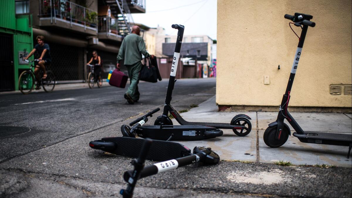 Scooters sit in an alley near the Venice Beach boardwalk in July. Los Angeles Councilman Paul Koretz has proposed banning the vehicles until city officials approve regulations governing their use.