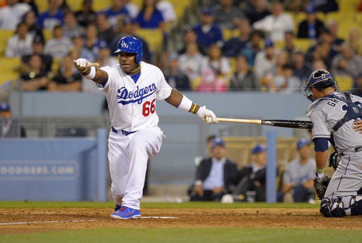 Dodgers right fielder Yasiel Puig strikes out against the Padres in the eighth inning Wednesday night.