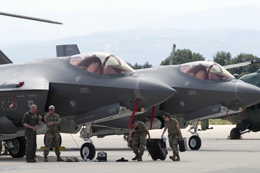 FILE - U.S. military personnel work near F-35 fighter jets of the Vermont Air National Guard, parked in the military base at Skopje Airport, North Macedonia, on Friday, June 17, 2022. The Czech government on Wednesday, Sept. 27, 2023 approved a Defense Ministry plan to acquire 24 U.S. F-35 fighter jets in a deal worth some 150 billion Czech crowns ($6.5 billion). (AP Photo/Boris Grdanoski, file)
