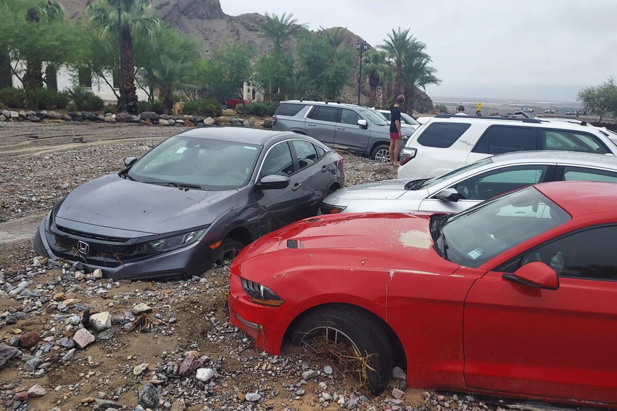 Mud and debris from flash flooding trap vehicles at the Inn at Death Valley in Death Valley National Park on Friday. 