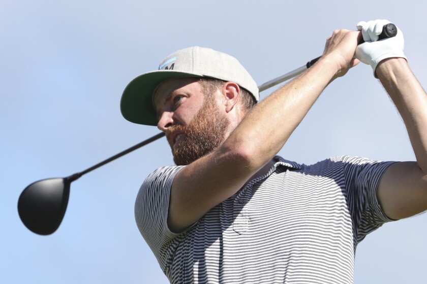 Chris Kirk follows his shot off the first tee during the third round at the Sony Open golf tournament Saturday, Jan. 16, 2021, in Honolulu. (AP Photo/Marco Garcia)