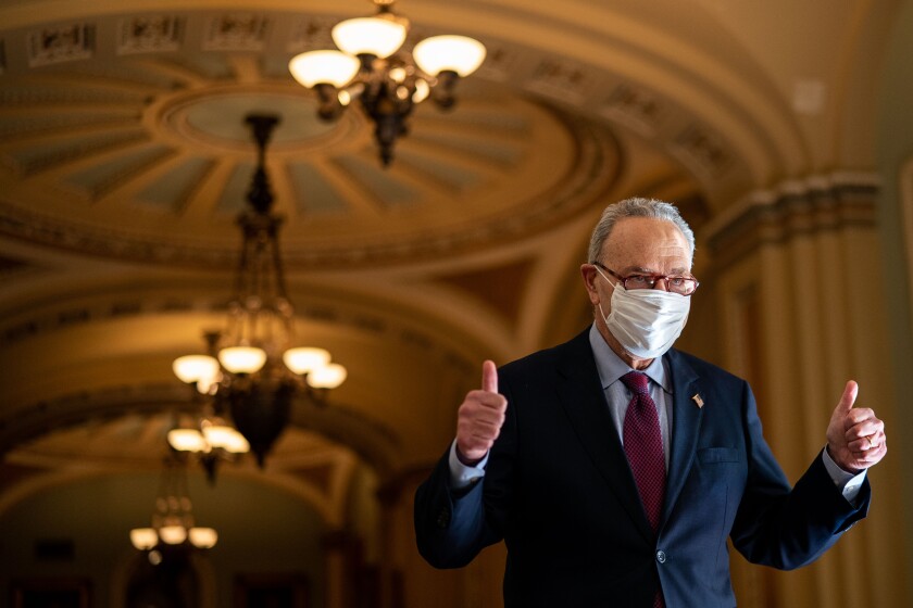A masked senator gives a thumbs-up