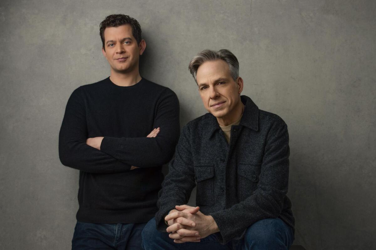 Biden’s cognitive decline and cover-up explored in new book 2 Alex Thompson stands against a wall with arms crossed while Jake Tapper sits with hands folded.