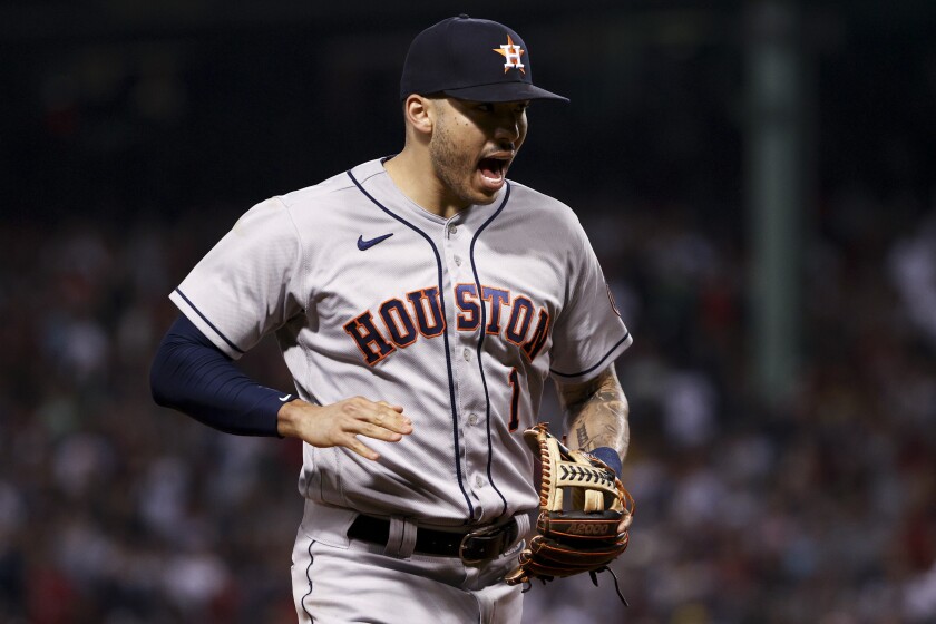 FILE - Houston Astros shortstop Carlos Correa celebrates the end of the fifth inning against the Boston Red Sox in Game 5 of baseball's American League Championship Series on Oct. 20, 2021, in Boston. There are 141 major league free agents waiting for a freeze on roster transactions to lift upon the agreement of a new collective bargaining agreement. Carlos Correa, Freddie Freeman and Kris Bryant are among the top players still on the market.(AP Photo/Winslow Townson, File)