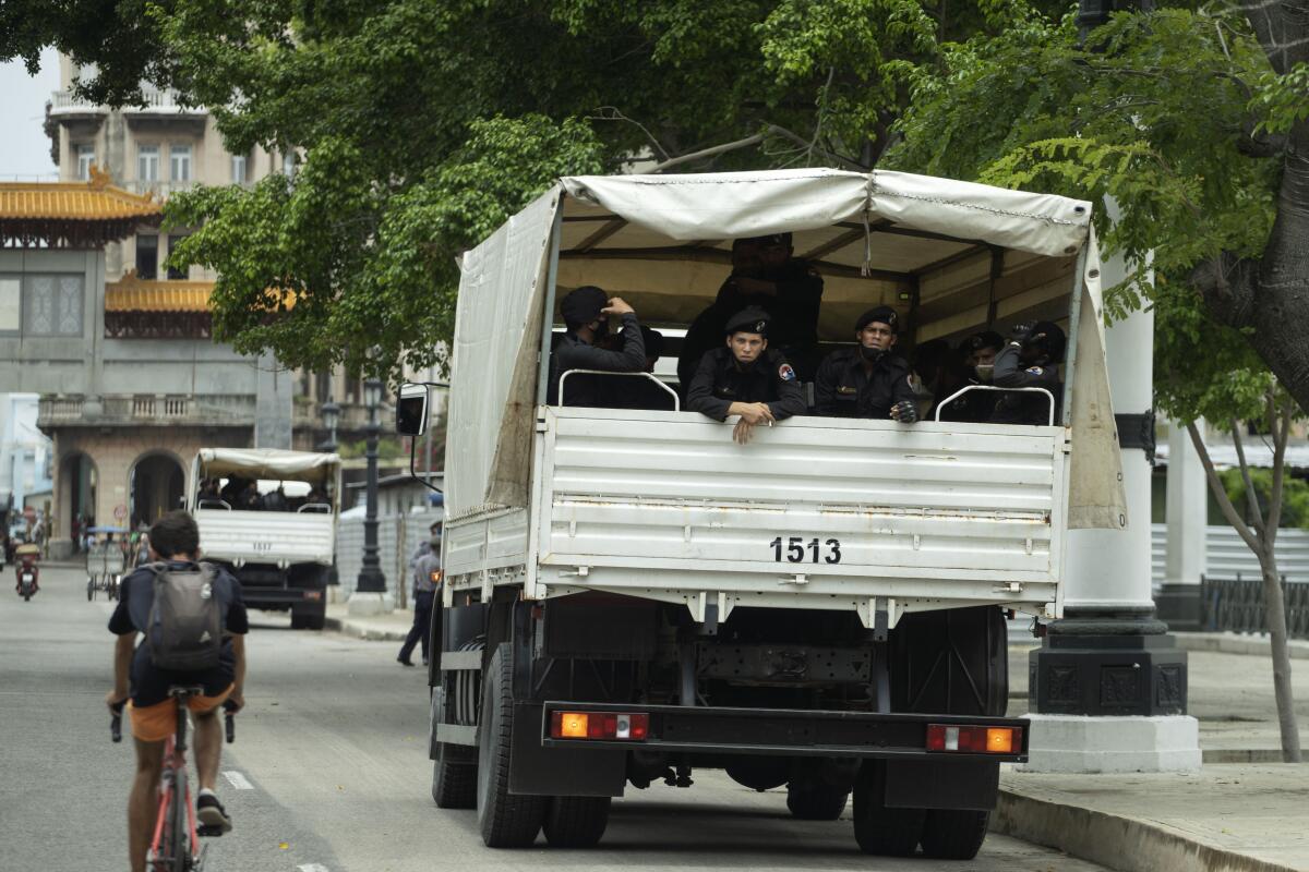 Police officers sitting back of truck