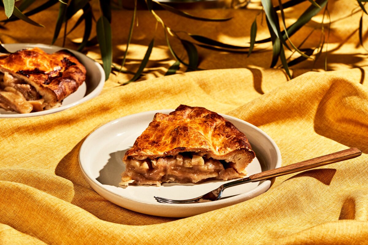 shot of a slice of pie on a plate with a fork on it