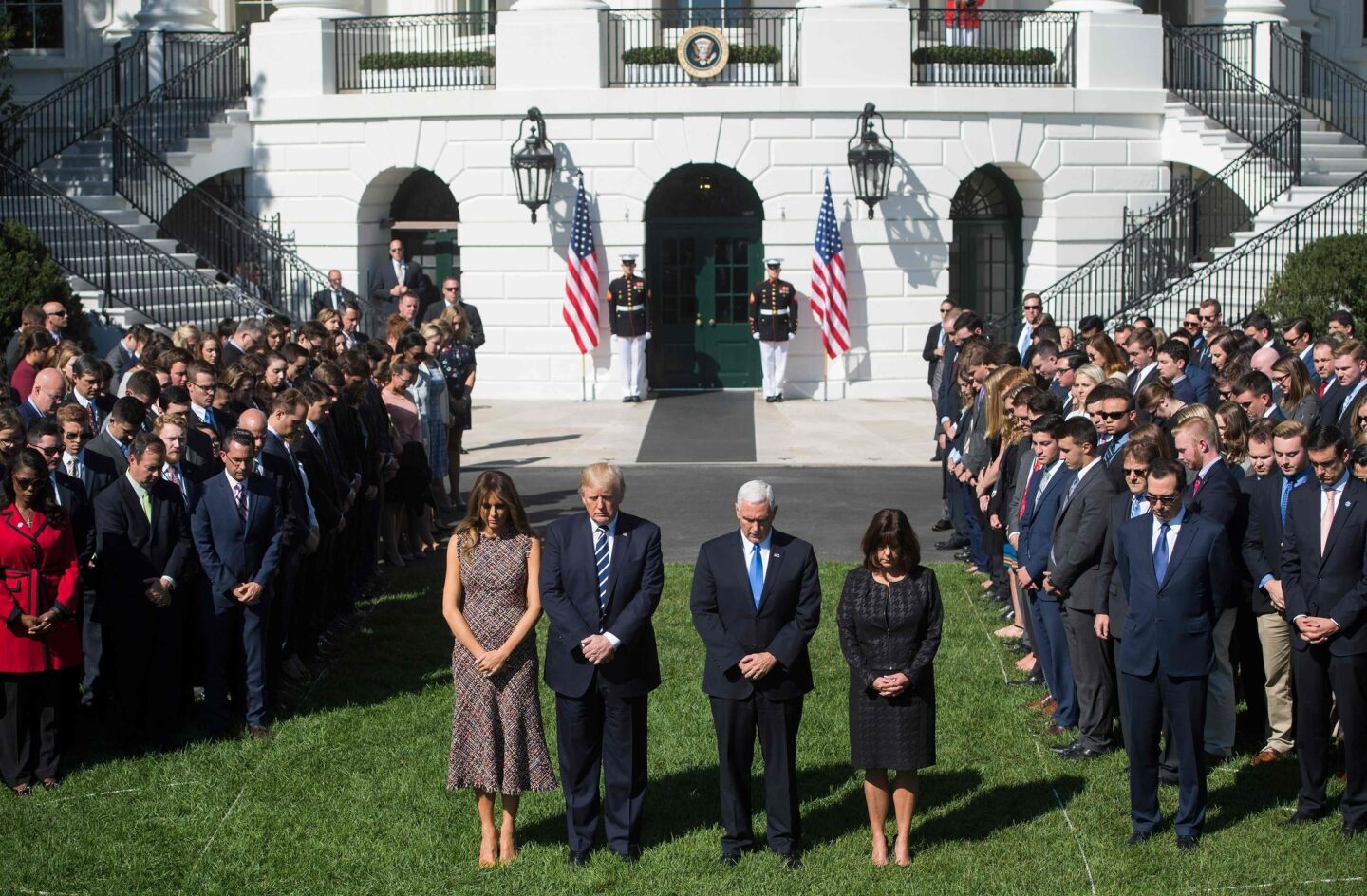 President Donald Trump, First Lady Melania Trump, Vice President Mike Pence and his wife, Karen, participate in a moment of silence on the South Lawn of the White House for victims of the Las Vegas mass shooting.