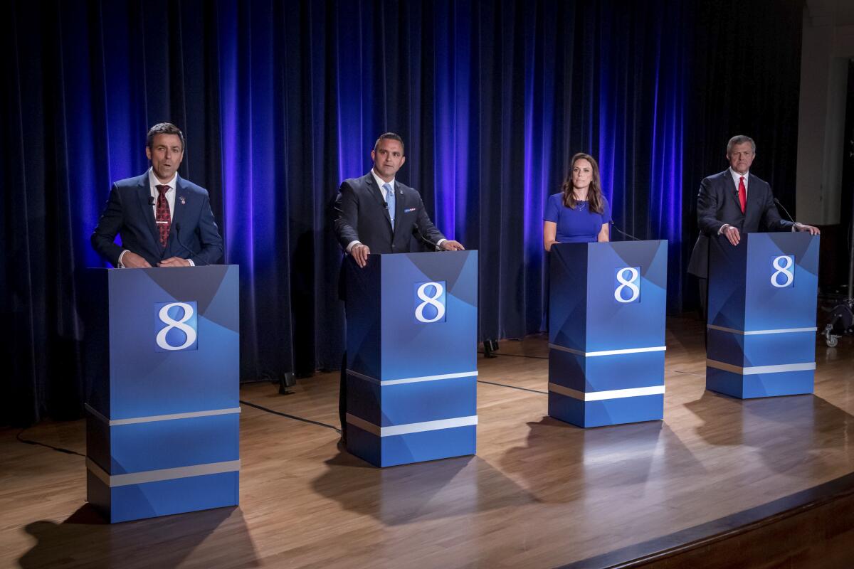 FILE - Michigan Republican candidates for governor Ryan Kelley, of Allendale, from left, Garrett Soldano, of Mattawan, Tudor Dixon, of Norton Shores and Kevin Rinke, of Bloomfield Township, appear at a debate in Grand Rapids, Mich., July 6, 2022. (Michael Buck/WOOD TV8 via AP, File)