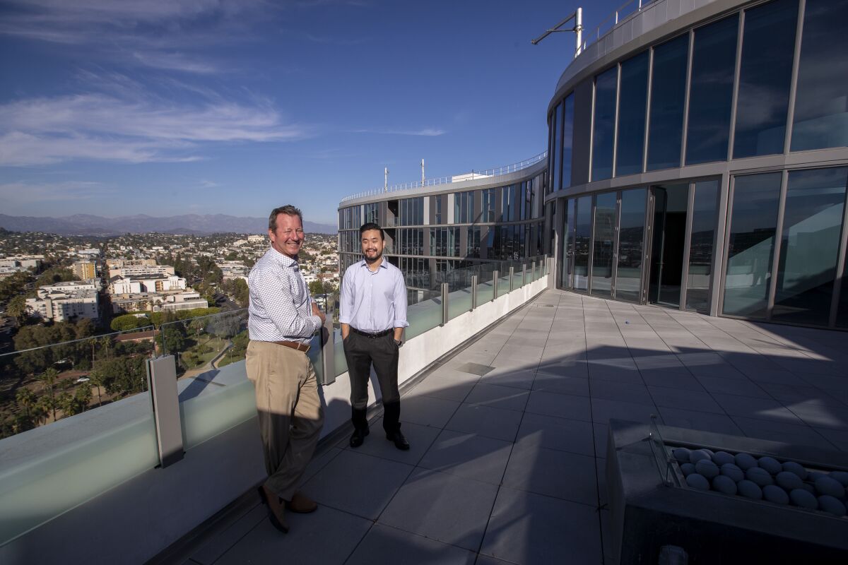 Developers Scott Dobbins, left, and Garrett Lee stand outside a Kurve penthouse.