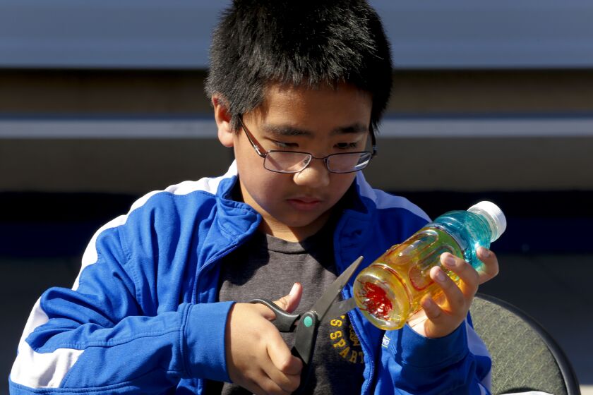 On Tuesday February 25, 2020, Samuel Sunico, a 6th grader from St. Charles Catholic School in south San Diego begins to cut his art project made from a water bottle into a wind ornament. Sunico was among the student that helped remove trash from Robert Egger, Sr. South Bay Community Park.