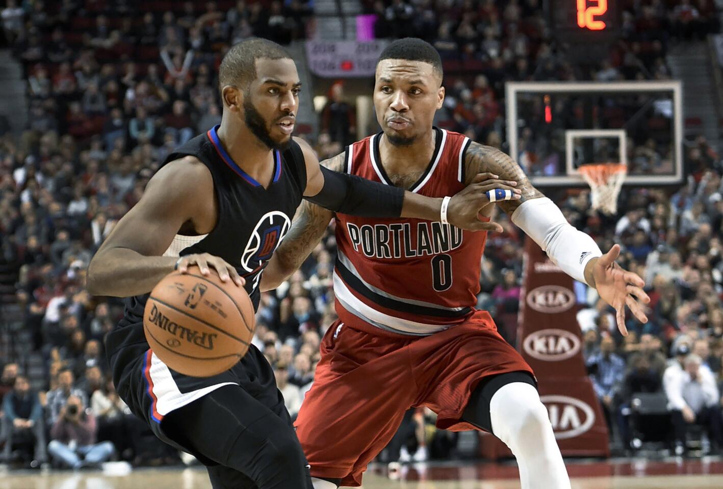Clippers guard Chris Paul (3) tries to get past Trail Blazers guard Damian Lillard during the second half.