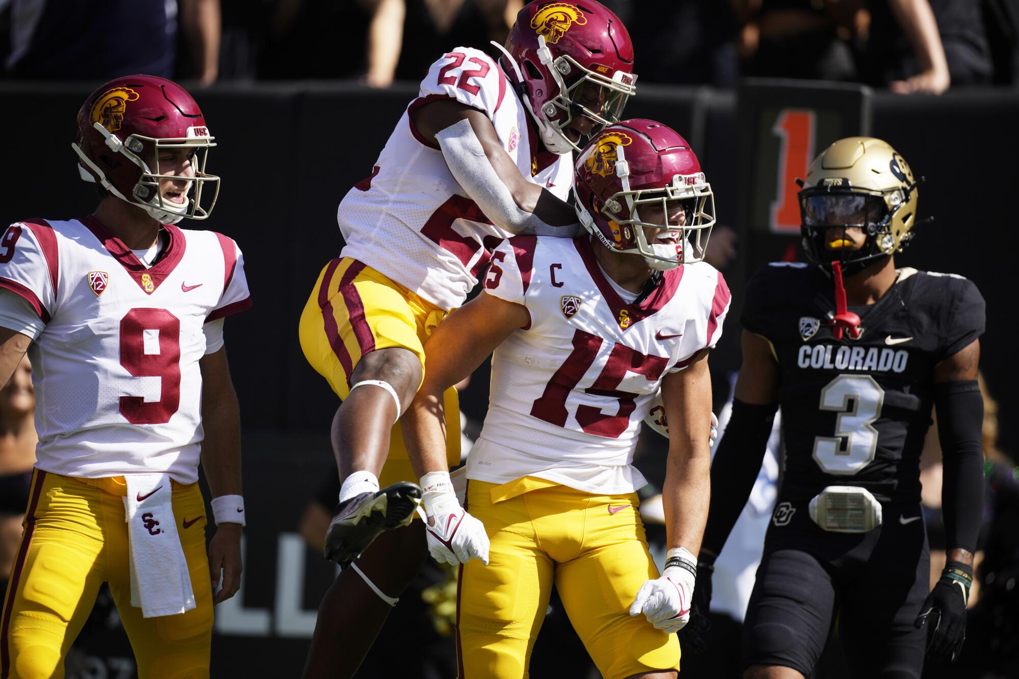 USC wide receiver Drake London celebrates with running back Darwin Barlow and quarterback Kedon Slovis.