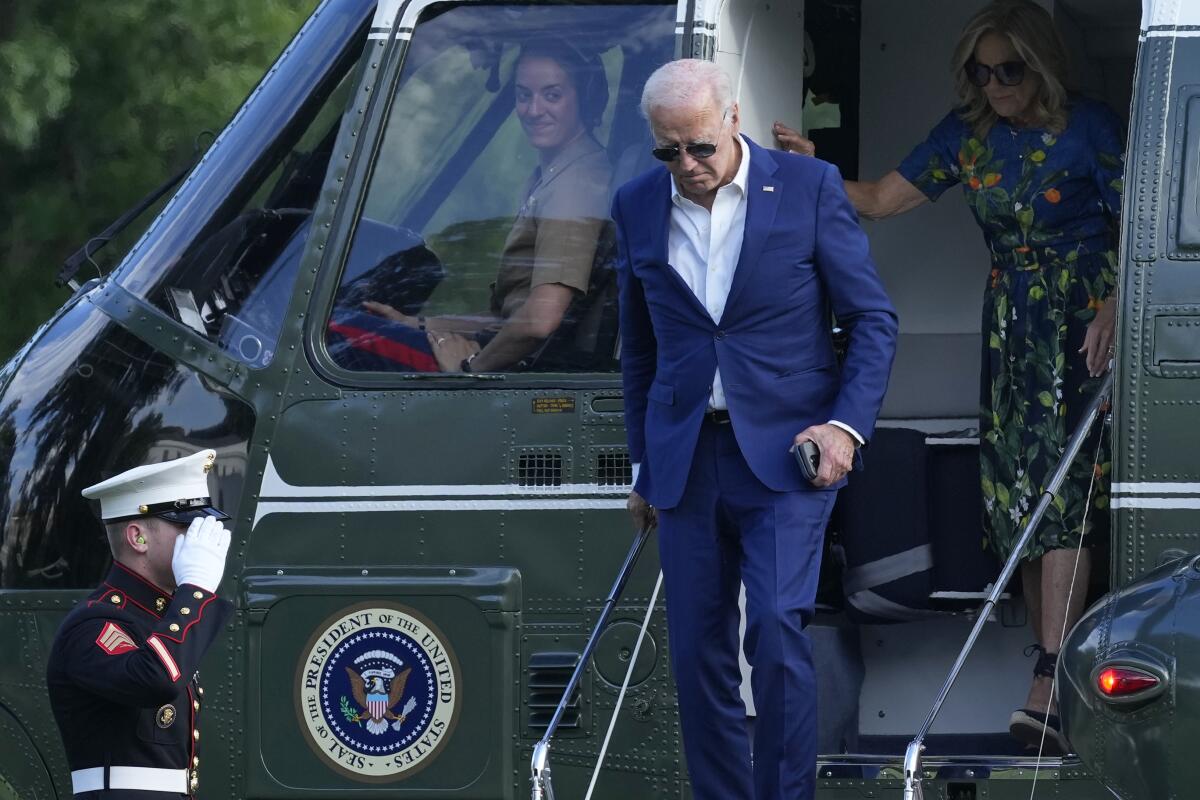 President Biden and First Lady Jill Biden disembarking from a helicopter