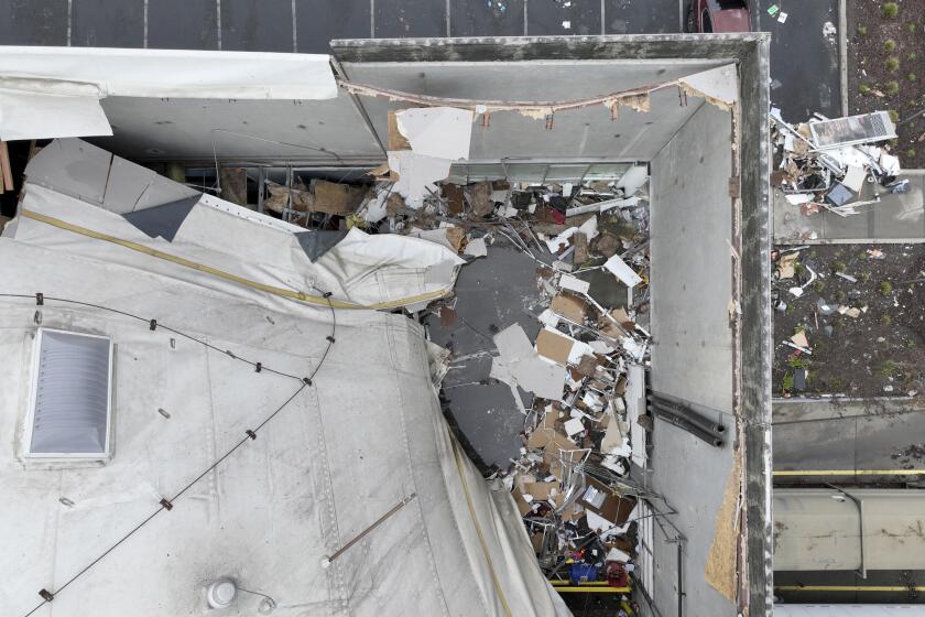 A drone image of a collapsed roof at a Peet’s Coffee distribution center in Oakland on Friday.