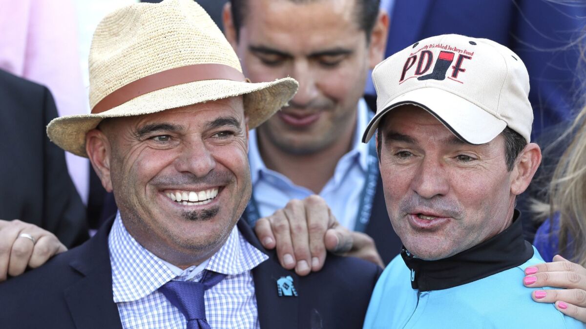 Trainer Peter Miller, left, and jockey Kent Desormeaux stand in the winner's circle after Roy H won the 2017 Breeders' Cup Sprint at Del Mar.