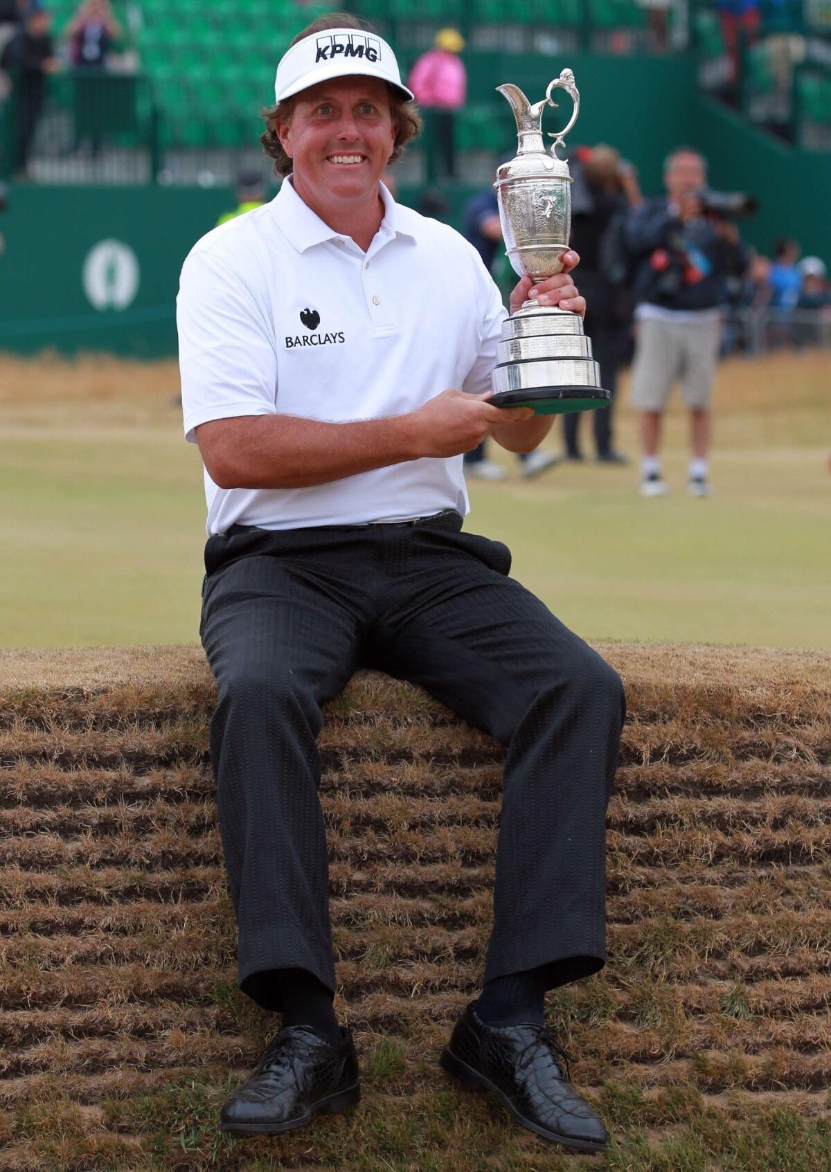 Phil Mickelson poses with the Claret Jug trophy after winning the British Open on Sunday.