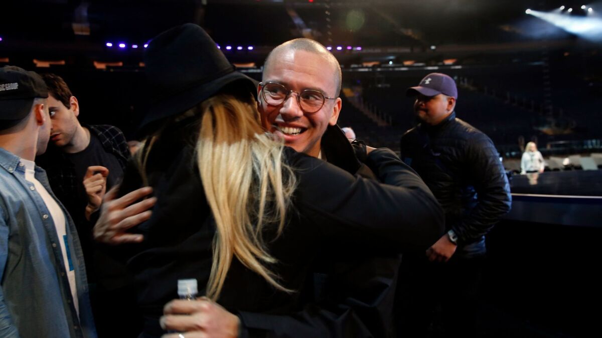 Logic greets fan Linda Wolfe, of El Paso, Texas, after rehearsing for the Grammy Awards.