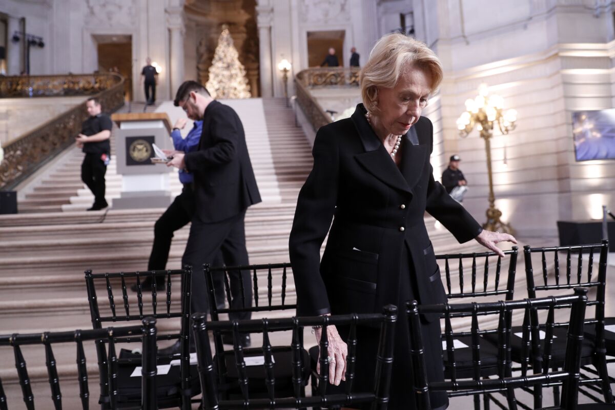 FILE - San Francisco Chief of Protocol Charlotte Mailliard Shultz makes preparations prior to a service celebrating the life of Mayor Ed Lee at San Francisco City Hall in San Francisco, Sunday, Dec. 17, 2017. Shultz, the long-reigning chief of San Francisco protocol and unofficial aide to 10 mayors, died Friday, Dec. 3, 2021, of complications from cancer. She was 88. (Scott Strazzante/San Francisco Chronicle via AP, Pool,File)