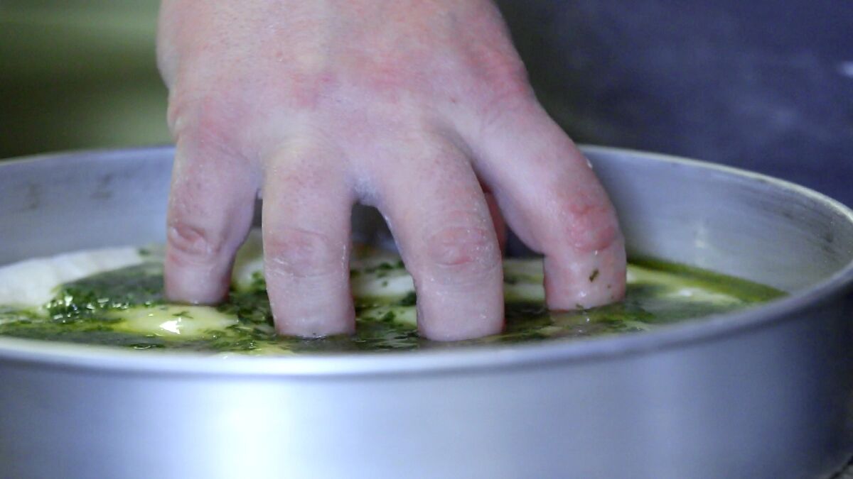 Step 4: "Make the claw with your hands and Bruce Lee the basil oil in the dough so you get these beautiful green streaks in the bread," Duff Goldman says.
