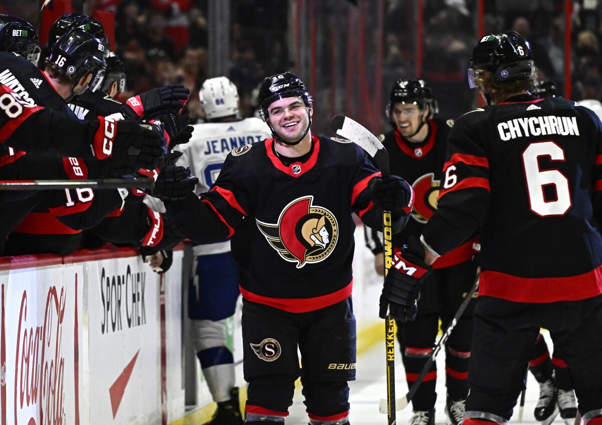 Ottawa Senators right wing Alex DeBrincat (12) celebrates after his second goal against the Tampa Bay Lightning with teammates during first-period NHL hockey game action in Ottawa, Thursday, March 23, 2023. (Justin Tang/The Canadian Press via AP)