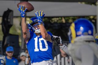 Rams receiver Cooper Kupp hauls in a pass during Rams training camp.