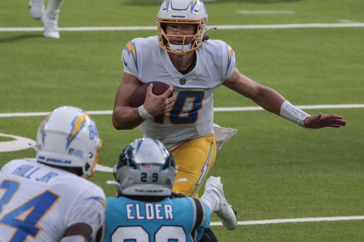 Chargers rookie quarterback Justin Herbert scrambles against the Carolina Panthers on Sept. 27.