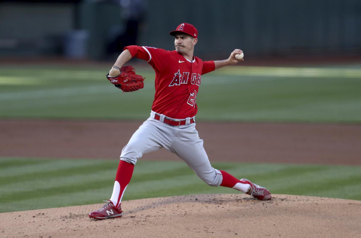 Angels' Andrew Heaney throws to an Oakland Athletics batter.