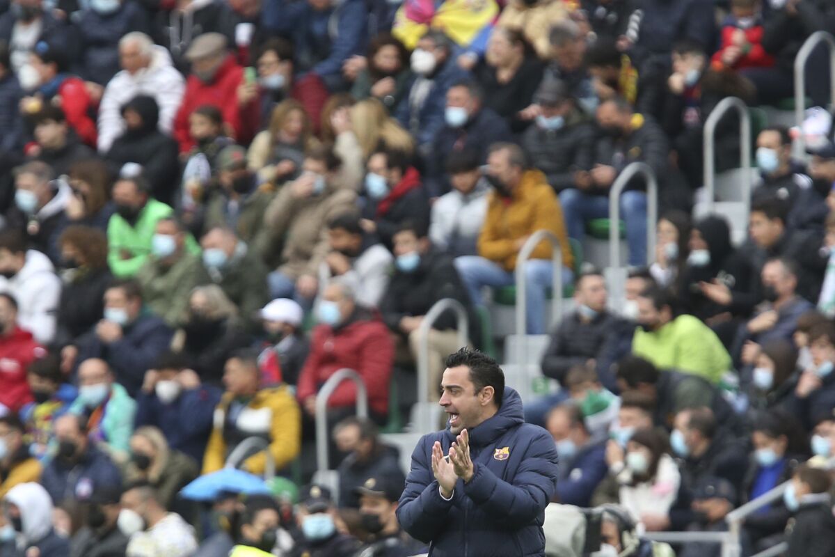 Barcelona's head coach Xavi Hernandez applauds during a Spanish La Liga soccer match between Elche and Barcelona at the Martinez Valero stadium in Elche, Spain, Sunday, March 6, 2022. (AP Photo/Alberto Saiz)