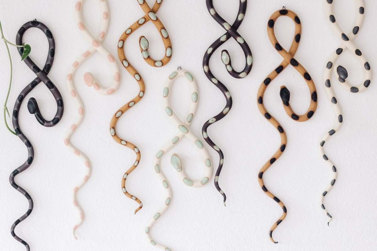 Squiggly snake art hanging on a wall.