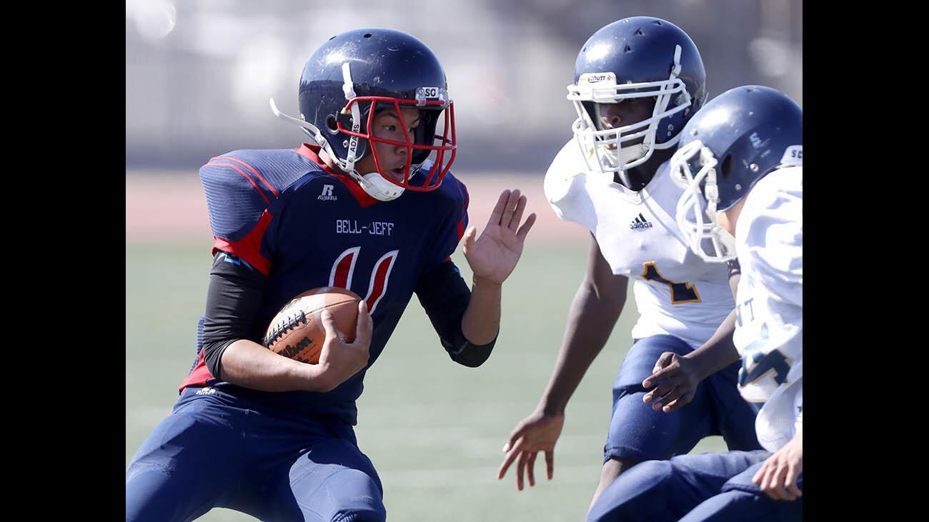 Bell Jeff high School football player #11 Ronald Jurok tries to avoid tacklers in home game vs. Lighthouse Christian School, at Burroughs High School's Memorial Field in Burbank on Saturday, Oct. 28, 2017.