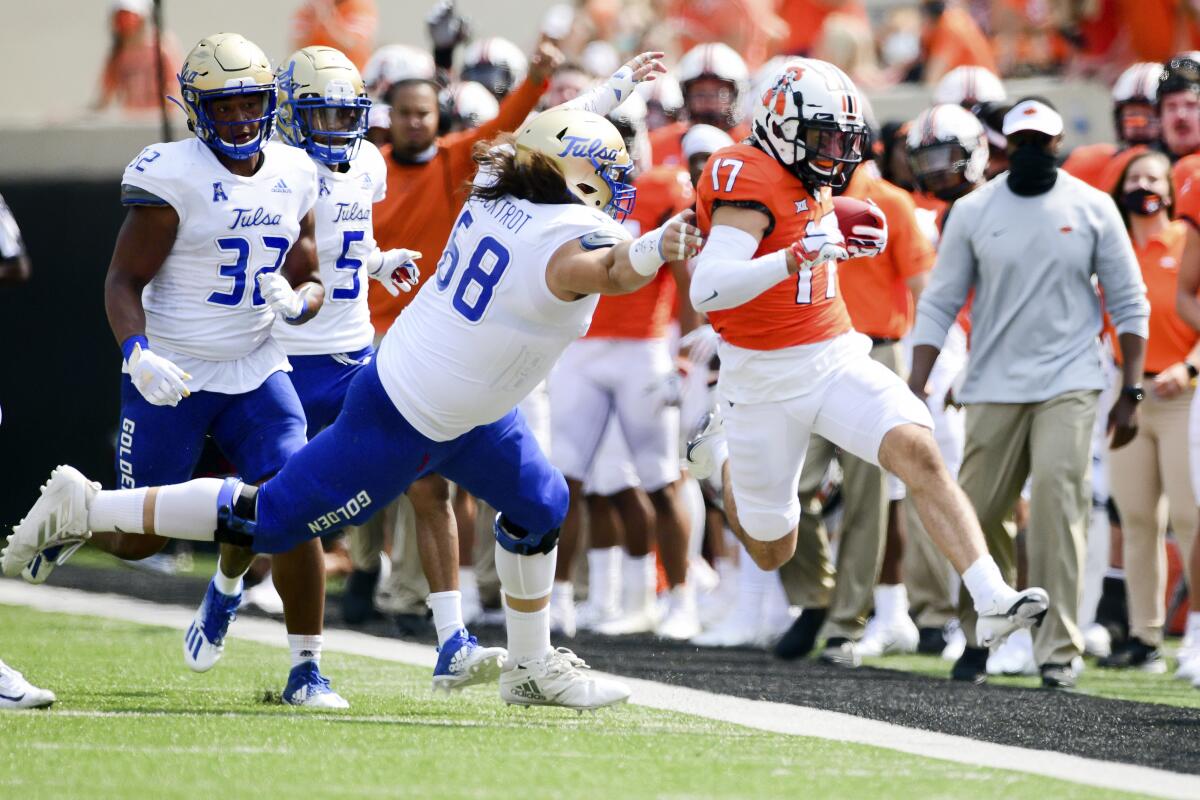 Tulsa linebacker Deven Lamp (58) forces Oklahoma State receiver Dillon Stoner (17) out of bounds on Sept 19, 2020.