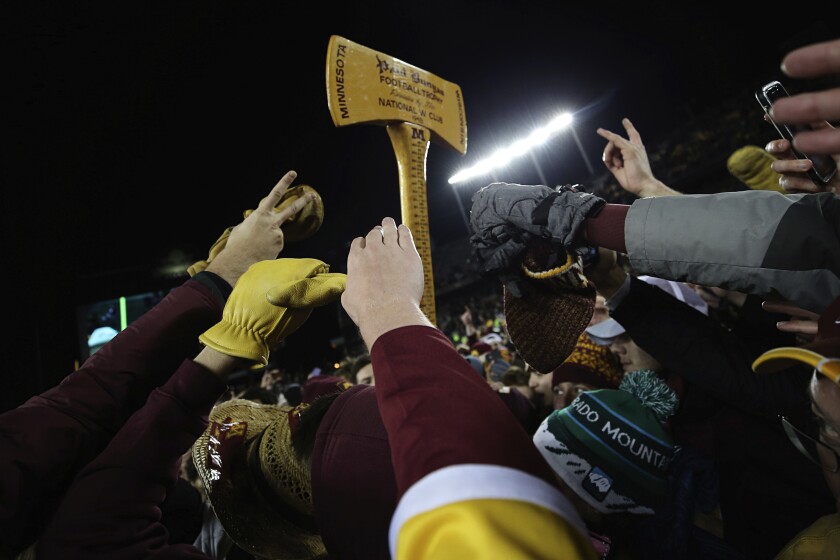 Minnesota fans reach up toward Paul Bunyan's Axe after the Gophers defeated Wisconsin.