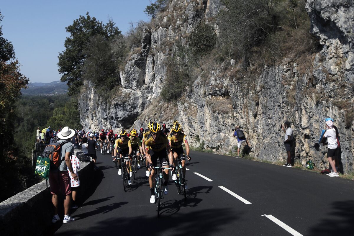 Team Jumbo - Visma riders lead the pack during the stage 15 of the Tour de France cycling race over 174 kilometers (108 miles), with start in Lyon and finish in Grand Colombier, Sunday, Sept. 13, 2020. (AP Photo/Christophe Ena)