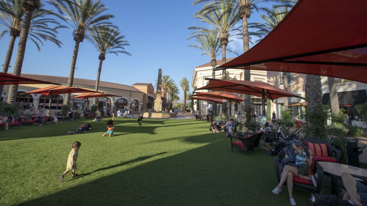 Shoppers take advantage of the redesigned Irvine Spectrum Center, where 30 new merchants have replaced the old Macy's anchor store. The Irvine Spectrum Center is spending heavily to keep people coming.