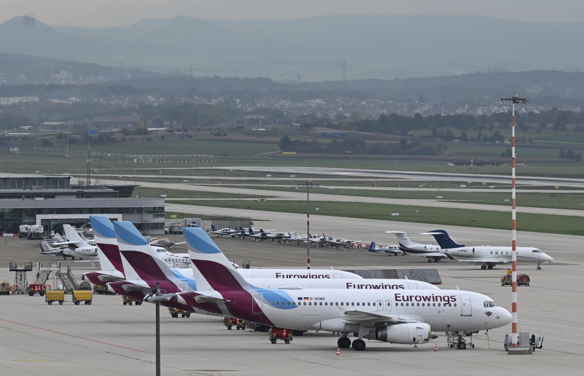 Eurowings aircrafts are parked at the airport in Stuttgart, Germany, Thursday, Oct. 6, 2022. A pilots strike at budget airline Eurowings has forced the German carrier to cancel hundreds of flights Thursday. The airline said about half of its 500 daily flights would be nixed, affecting tens of thousands of passengers in Germany and elsewhere in Europe. (Bernd Weissbrod/dpa via AP)