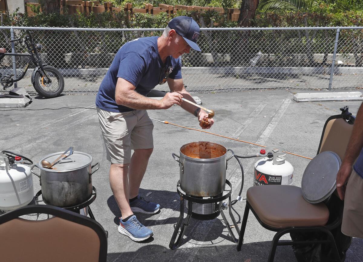 Dan Conroy from the Laguna Beach Fire Department serves up their second-place chili recipe on Saturday.
