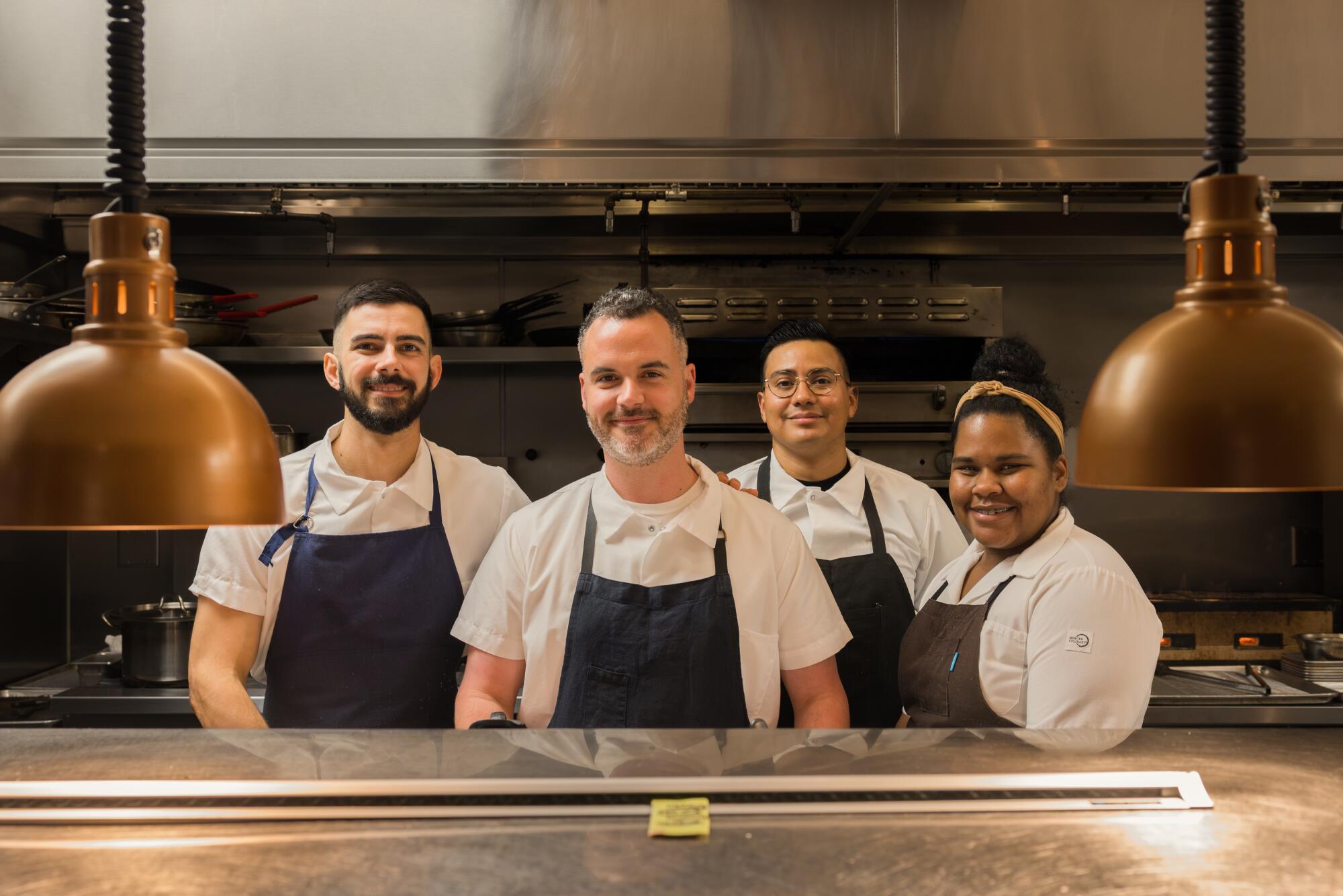 Bar Chelou's chefs smile for a photo in the kitchen.