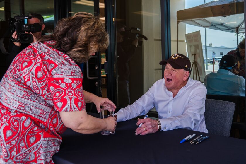 Padre Hall of Famer Randy Jones after signing his autograph on a baseball during a meet and greet at Home of Guiding Hands in El Cajon on April 26, 2022.