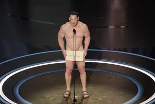 John Cena nude, holding a sandals and a big envelope in front of his groin
