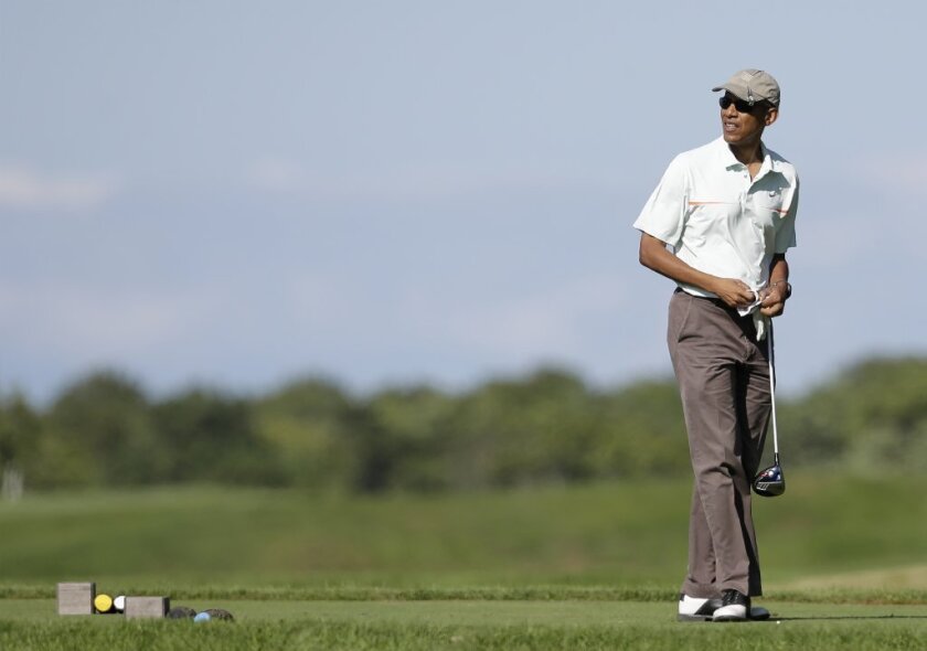 President Obama golfs Thursday on the island of Martha's Vineyard during a two-week vacation.