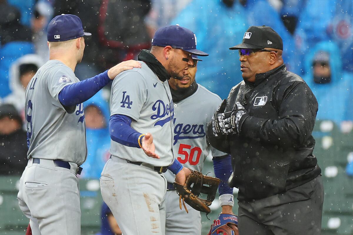 Dodgers third baseman Miguel Rojas argues with umpire Laz Diaz.