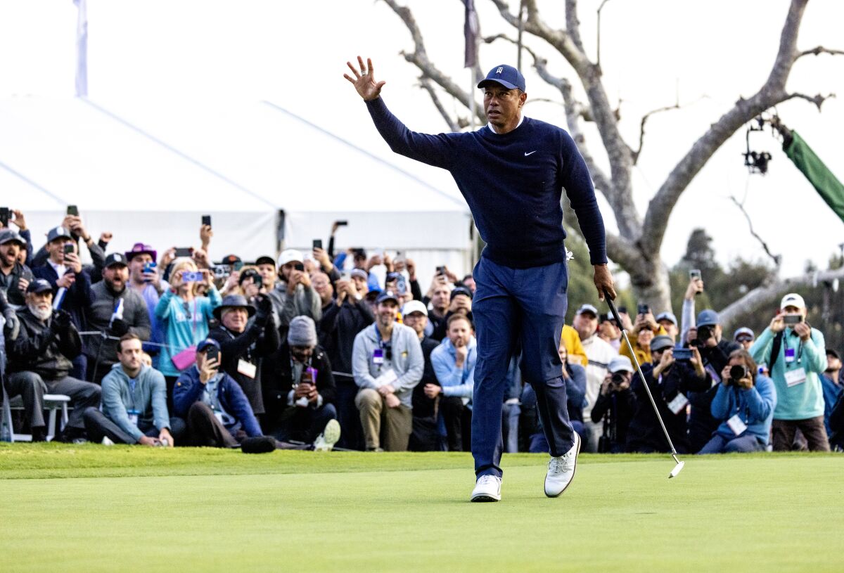 Tiger Woods acknowledges the crowd after a birdie on the 18th hole during the first round of the Genesis Invitational.