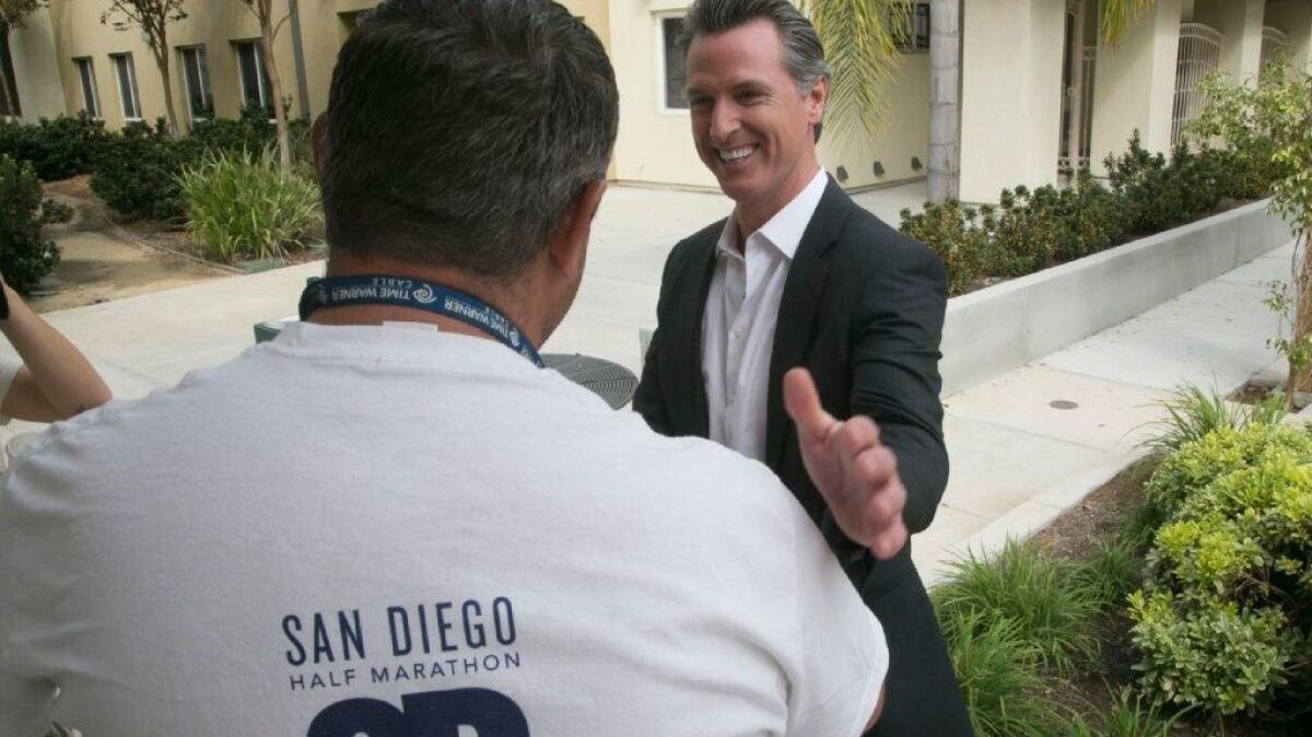 California Lt. Governor Gavin Newson, the Democratic candidate for Governor, spoke with Michael Murray, a client at the Veterans Village of San Diego during a campaign stop on Friday, October 12, 2018.